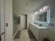 Bathroom with double vanity, walk in shower and separate toilet area at 3650 Yacobian Pl, Orlando, FL 32824