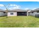 House with backyard, grassy lawn, and screened patio at 2717 Greenlands St, St Cloud, FL 34772