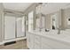Bathroom with double vanity, large mirror, and shower at 188 Ridgemont Ct, Davenport, FL 33896