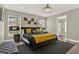 King-size bed in spacious main bedroom with window and bench at 188 Ridgemont Ct, Davenport, FL 33896
