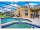 Inviting pool area with screened enclosure, patio furniture, and grill at 188 Ridgemont Ct, Davenport, FL 33896