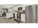 Modern kitchen with white cabinets and stainless steel appliances at 188 Ridgemont Ct, Davenport, FL 33896