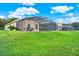 House with a large backyard, screened pool, and lush grass at 188 Ridgemont Ct, Davenport, FL 33896