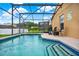 Relaxing screened pool and spa with patio seating at 188 Ridgemont Ct, Davenport, FL 33896