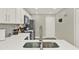 Modern kitchen with white cabinets and stainless steel sink at 188 Ridgemont Ct, Davenport, FL 33896