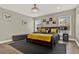 King-size bed in spacious main bedroom with window and bench at 188 Ridgemont Ct, Davenport, FL 33896