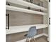 Built-in home office with desk, shelves, and gray chair at 188 Ridgemont Ct, Davenport, FL 33896