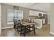 Bright dining area with a large wooden table and black chairs at 188 Ridgemont Ct, Davenport, FL 33896
