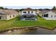 Aerial view of house with pool and lakefront access at 957 Whispering Cypress Ln, Orlando, FL 32824