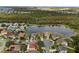 Wide aerial view showing lakefront home and community at 957 Whispering Cypress Ln, Orlando, FL 32824