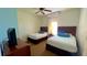 Two twin beds and TV in a bright bedroom at 8101 Resort Village Dr, Orlando, FL 32821