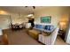 Living area with a sofa, armchair, coffee table, and dining area at 8101 Resort Village Dr, Orlando, FL 32821