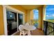 Balcony with table and chairs overlooking a lake at 8101 Resort Village Dr, Orlando, FL 32821