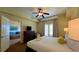 Comfortable main bedroom with a king-size bed, dresser, and access to a living area at 8101 Resort Village Dr, Orlando, FL 32821