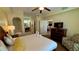 King-size bed in a well-lit bedroom with ensuite bathroom access and a sitting area at 8101 Resort Village Dr, Orlando, FL 32821