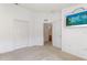 Bedroom with double doors leading to the bathroom and a mirrored wall hanging at 117 Verbena St, Davenport, FL 33837