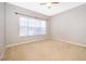 Bedroom with carpeted floor, window with blinds, and ceiling fan at 2352 Grand Central Pkwy # 9, Orlando, FL 32839