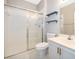 Bathroom with shower, toilet, and vanity with floating shelves at 2352 Grand Central Pkwy # 9, Orlando, FL 32839