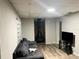 Living room featuring a fireplace and wood-look floors at 1025 Susan St, Leesburg, FL 34748