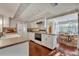 Bright kitchen, white cabinets, granite countertops, and view into dining area at 1001 Tuscany Pl, Winter Park, FL 32789