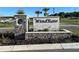 WindRose community entrance sign with stone pillars and landscaping at 6130 Galloping Dr, Apopka, FL 32712