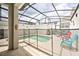 Screened-in pool area with lounge chairs and safety fence at 8988 Stinger Dr, Champions Gate, FL 33896