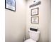 Small bathroom with toilet and rustic wall decor at 8988 Stinger Dr, Champions Gate, FL 33896