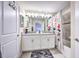 Double vanity bathroom with gray countertop and white cabinets at 8988 Stinger Dr, Champions Gate, FL 33896