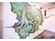Hallway with a lush jungle mural and wood floors at 8988 Stinger Dr, Champions Gate, FL 33896