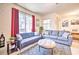 Gathering-friendly living room with comfortable seating and playful decor at 8988 Stinger Dr, Champions Gate, FL 33896