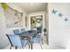 Outdoor patio with table and chairs, nautical theme at 8988 Stinger Dr, Champions Gate, FL 33896