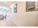 Long hallway with tile floors and framed artwork leading to dining area at 8988 Stinger Dr, Champions Gate, FL 33896