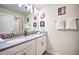 Double sink bathroom with gray countertop and superhero decor at 8988 Stinger Dr, Champions Gate, FL 33896