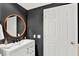 Contemporary bathroom with dark walls and round mirror at 322 E Central Blvd # 901, Orlando, FL 32801