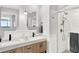 Elegant bathroom with double vanity, modern shower, and wood cabinets at 322 E Central Blvd # 901, Orlando, FL 32801