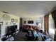Living room with a brown couch and a large TV at 1610 Crest Ave, Leesburg, FL 34748