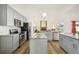 Updated kitchen featuring gray cabinets and granite countertops at 1546 Thornhill Cir, Oviedo, FL 32765
