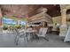 Outdoor pool bar with thatched roof and seating area at 8947 Bismarck Palm Rd, Kissimmee, FL 34747