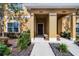 Front view of a tan townhome with a covered porch and landscaping at 8947 Bismarck Palm Rd, Kissimmee, FL 34747