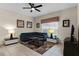 Bright living room featuring a comfy sectional sofa and a large window at 8947 Bismarck Palm Rd, Kissimmee, FL 34747