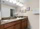 Double vanity bathroom with granite countertop and mirror at 8947 Bismarck Palm Rd, Kissimmee, FL 34747
