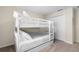 Well-lit bedroom featuring a white bunk bed with a full-size trundle at 8947 Bismarck Palm Rd, Kissimmee, FL 34747