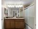 Double vanity bathroom with granite countertop and bathtub at 8947 Bismarck Palm Rd, Kissimmee, FL 34747