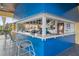 Bright blue outdoor bar with seating for guests at 8947 Bismarck Palm Rd, Kissimmee, FL 34747