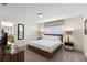 King-size bed in a well-lit bedroom with ensuite bathroom at 8947 Bismarck Palm Rd, Kissimmee, FL 34747