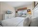 King-size bed in bright bedroom with window and dresser at 8947 Bismarck Palm Rd, Kissimmee, FL 34747