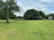 Green grassy backyard with trees and wooden fence at 4805 Hunting Lodge Dr, Saint Cloud, FL 34772