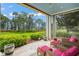 Relaxing screened porch overlooking lush landscape and tranquil water views at 10323 Kensington Shore Dr # 102, Orlando, FL 32827