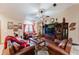 Living room with hardwood floors, leather furniture, and a large entertainment center at 3500 Sail Fish Ave, Fruitland Park, FL 34731