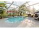 Inviting screened pool area, spacious patio, and lush landscaping at 3500 Sail Fish Ave, Fruitland Park, FL 34731